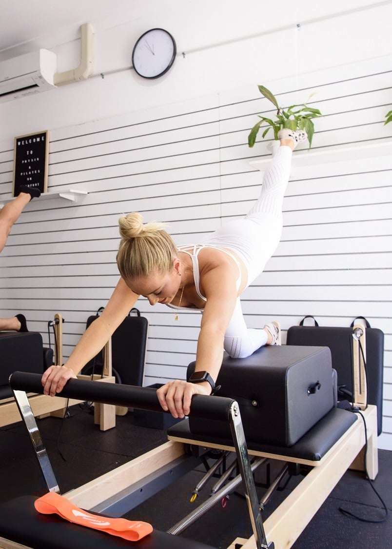 RESISTA Pilates Maple Reformer being used by Pilates instructor