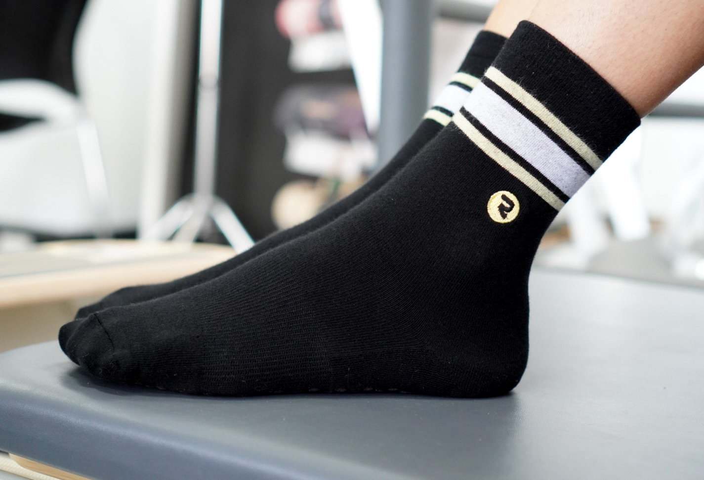 RESISTA Pilates Crew Grip Socks Black'n'Gold Hoops on reformer