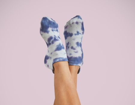 Resista Pilates Grip Socks Indigo on feet against a wall